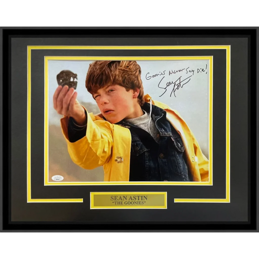 Signed Sean Astin 11x14 photo as young boy in yellow jacket holding black skull, framed with Goonies plaque