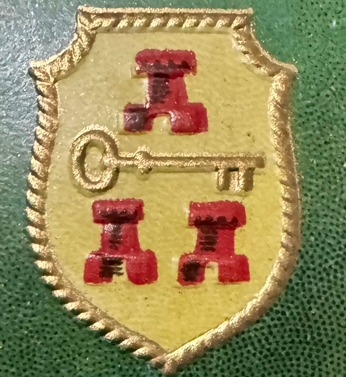Close-up of the Selector label's left shield: three red castle towers and a gold key on yellow inside a gold rope border