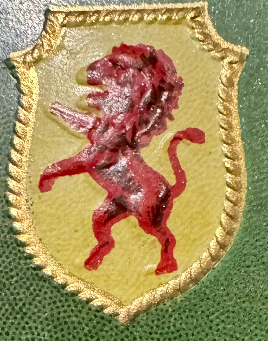Close-up of the Selector label's right shield: a red rampant lion on yellow inside a gold rope border