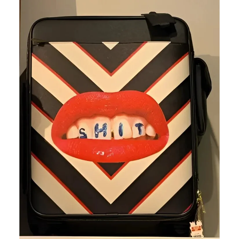 Seletti Toiletpaper travel kit with bold chevron pattern and red lips design