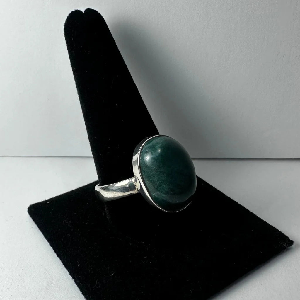 Serpentine ring with sleek silver band and oval deep green gemstone