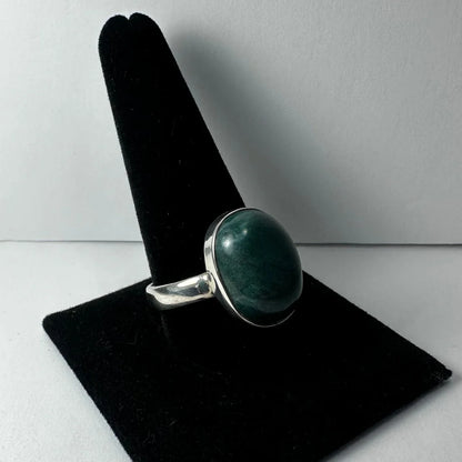 Serpentine ring with sleek silver band and oval deep green gemstone