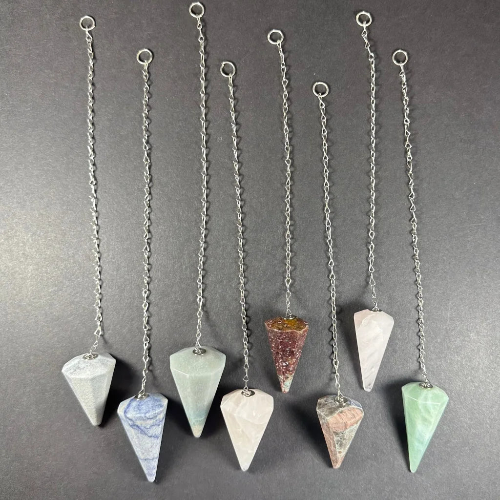 Seven natural stone pendulums with silver chains and rings