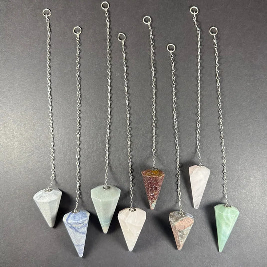 Seven natural stone pendulums with silver chains and rings