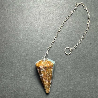 Polished triangular stone pendulum in earthy brown and green hues on silver chain