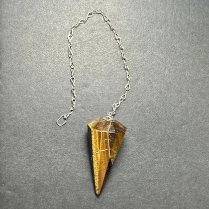 Golden-brown tiger eye stone pendulum on silver chain
