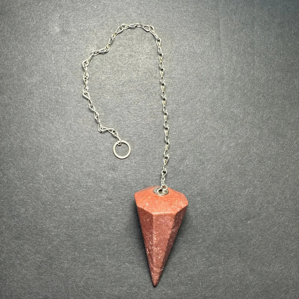 Reddish-brown faceted hematite stone pendulum on silver chain from Seven set