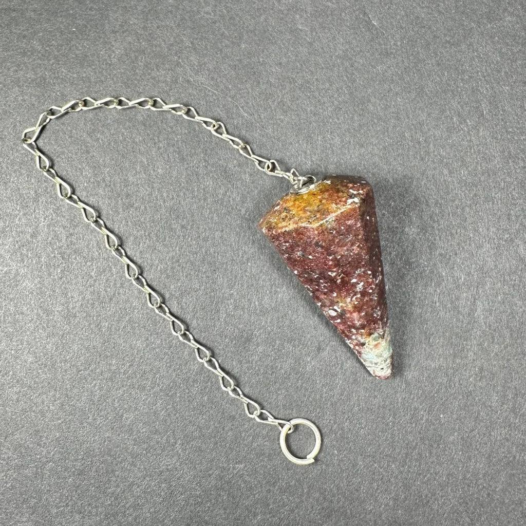 Polished red yellow triangular stone pendulum on silver chain
