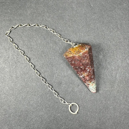 Polished red yellow triangular stone pendulum on silver chain