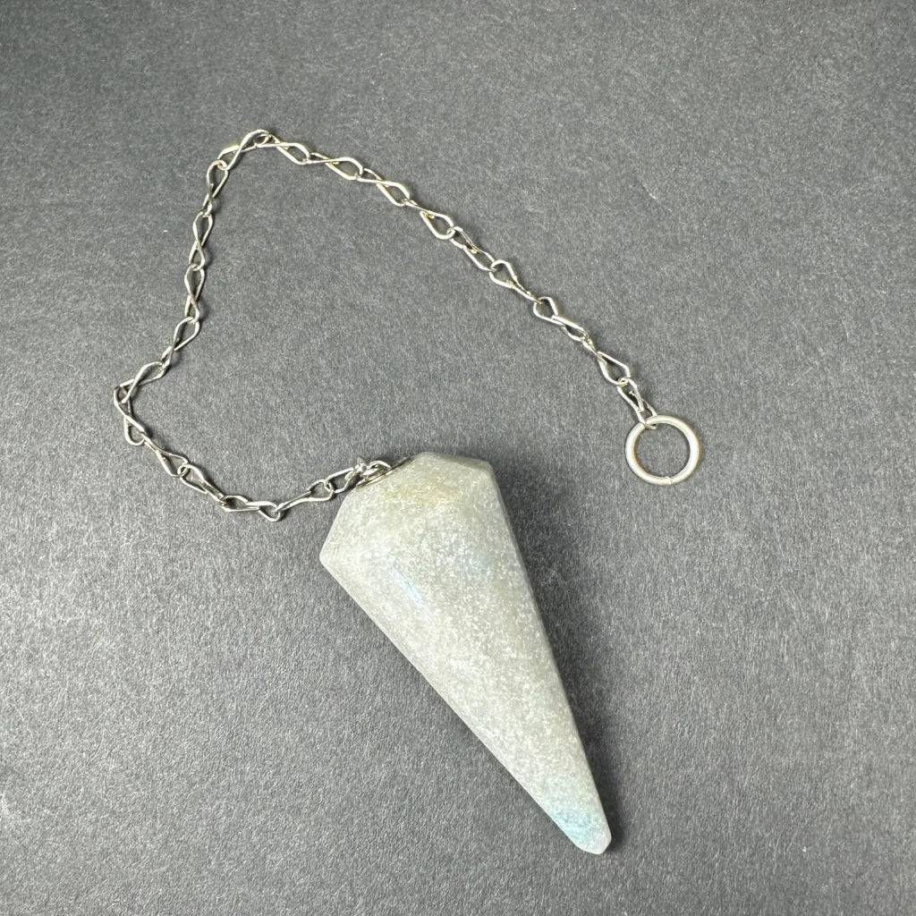 Light gray faceted stone pendulum with blue tip on silver chain