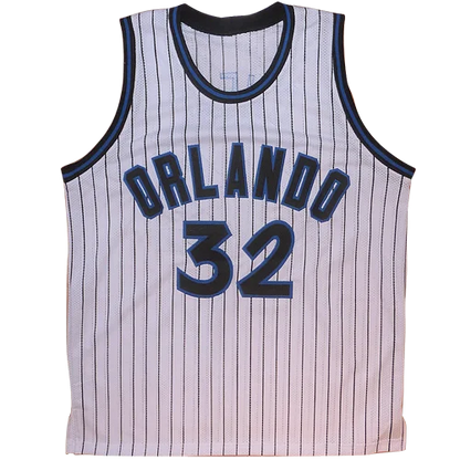 White pinstripe custom jersey featuring navy blue lettering and number 32 autographed by Shaquille O’Neal