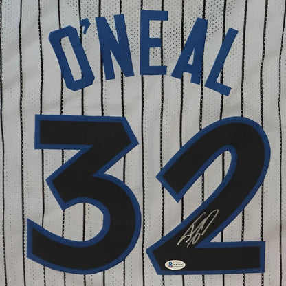 Back of a white pinstripe custom jersey with blue and black lettering featuring the name o’neal and number 32