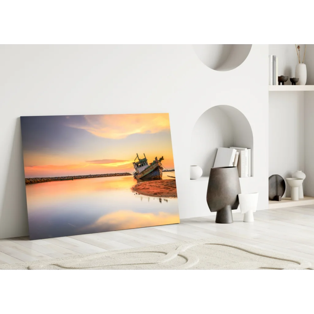 Serene sunset over water with weathered fishing boat in glass wall art