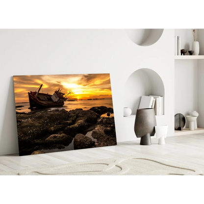 Dramatic sunset shipwreck glass wall art on rocky shores