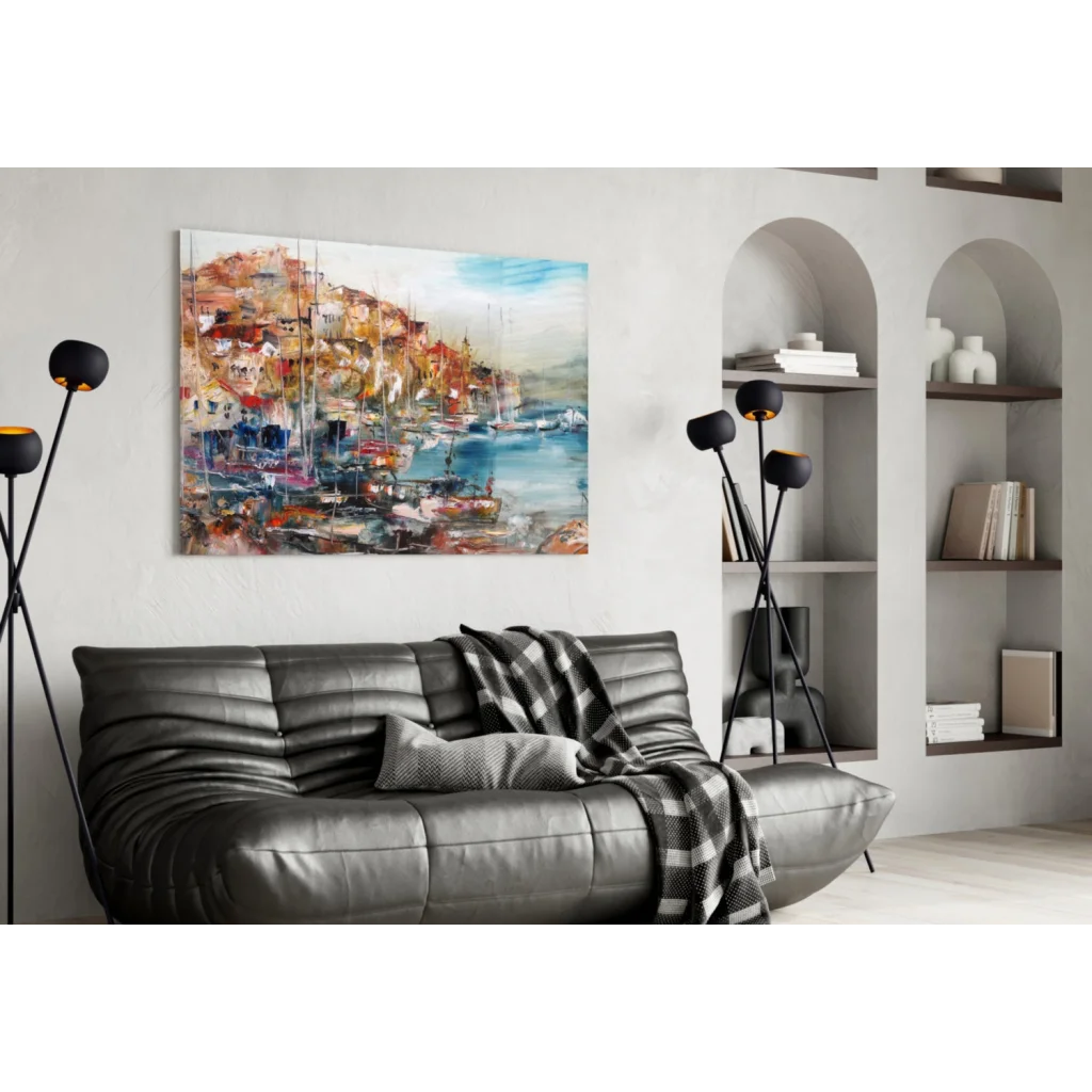 Vibrant abstract glass wall art of coastal town above gray sofa