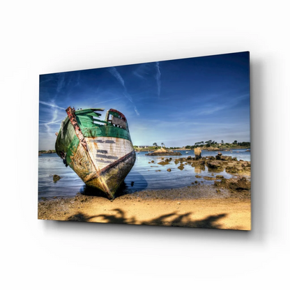 Weathered green boat on sandy shore glass wall art print