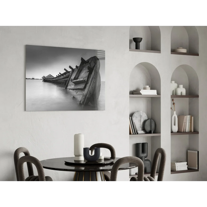 Stunning black-and-white glass wall art of weathered shipwreck boats on calm water