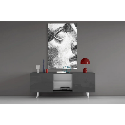Black-and-white abstract portrait canvas above gray console in glass wall art