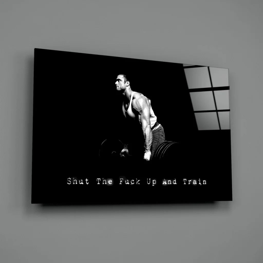 Muscular man lifting weights on black white canvas wall art with Shut Up and Train text