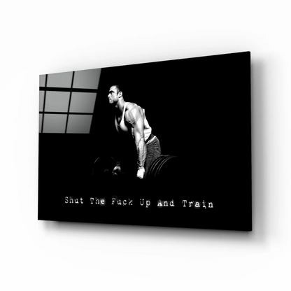 Muscular man lifting weights on black white canvas wall art with Shut Up and Train quote