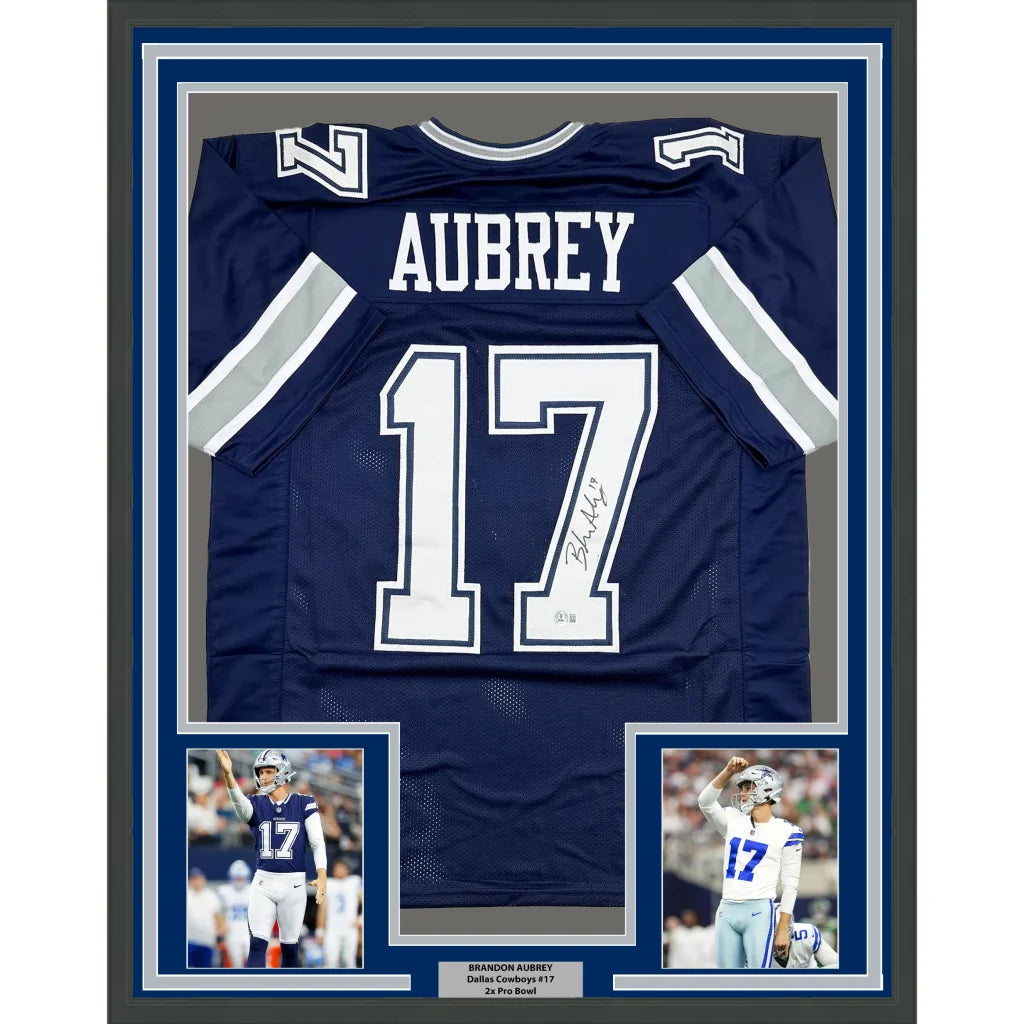 Signed navy blue football jersey in white lettering, framed