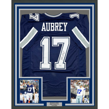 Signed navy blue football jersey in white lettering, framed