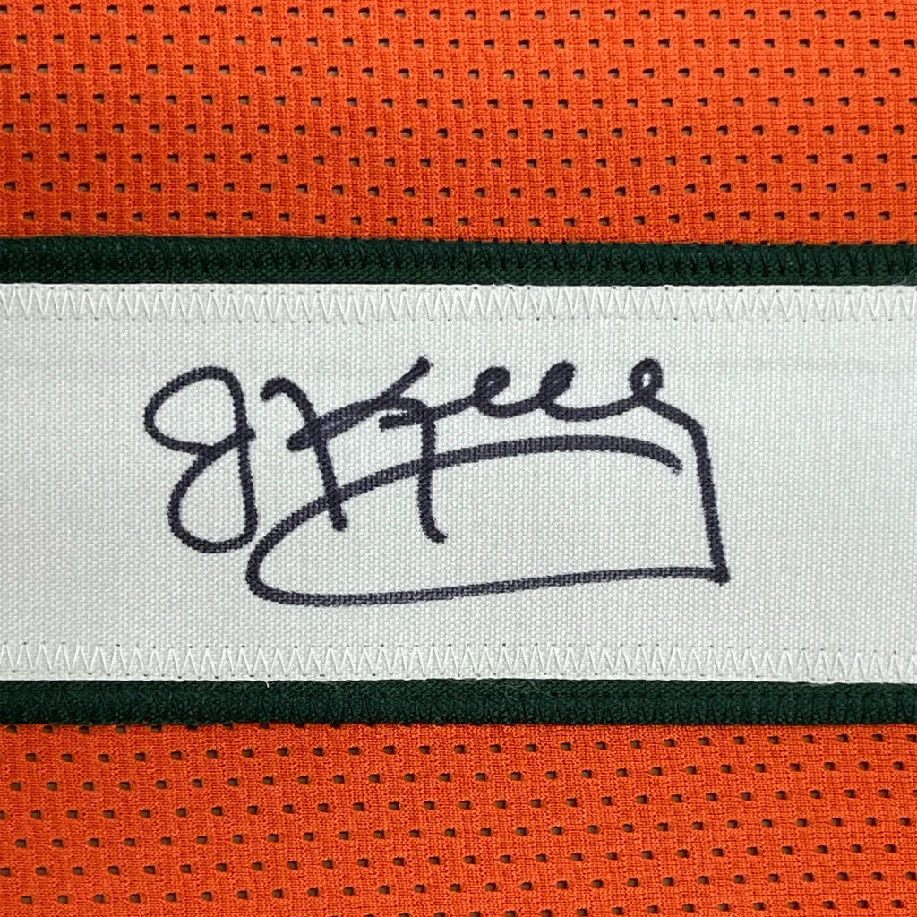 Orange football jersey with a signed white tag, perfect for your Man Cave decor