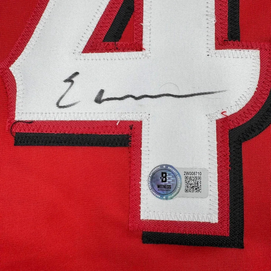 Red and white football jersey with number 41, autographed by player.