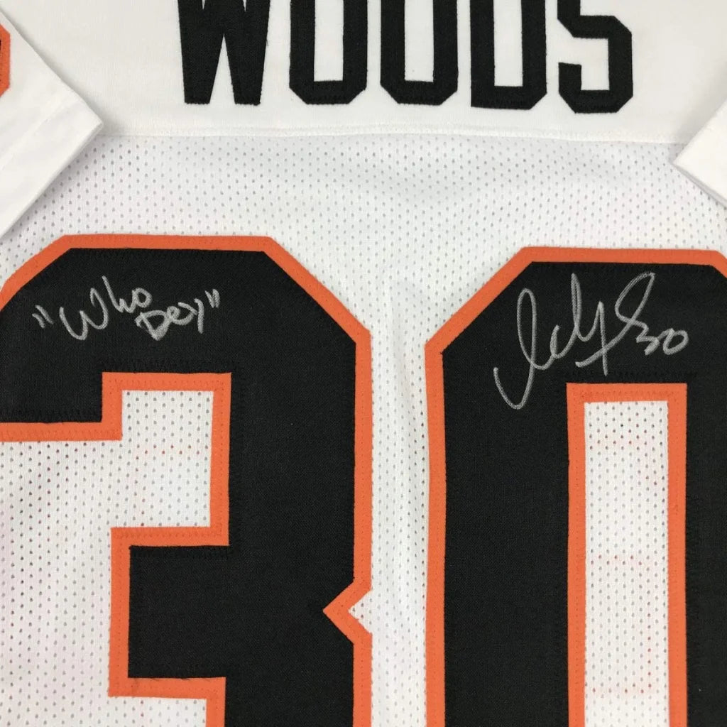 White custom jersey from professional sports league with black orange numbers and autographs