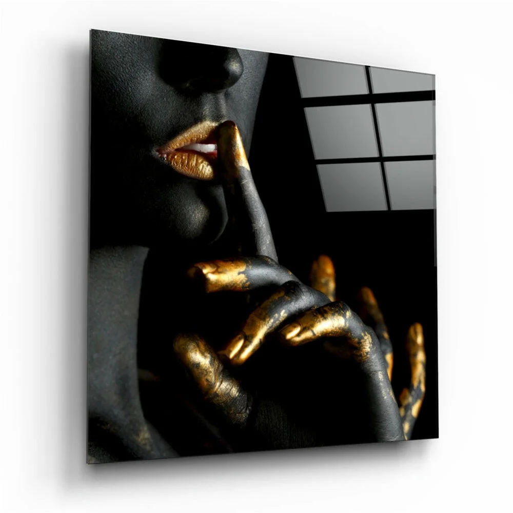 Black gold glass wall art panel of woman’s metallic face on dark canvas