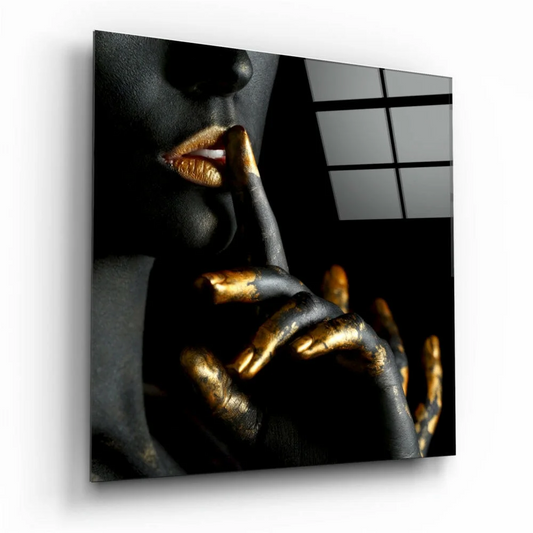 Black gold glass wall art panel of woman’s metallic face on dark canvas