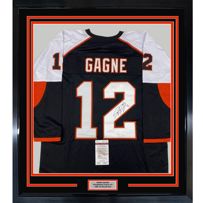 Framed black Philadelphia Flyers jersey #12 with "GAGNE" nameplate and signature, displayed front-facing with white and orange trim and JSA authentication certificate.