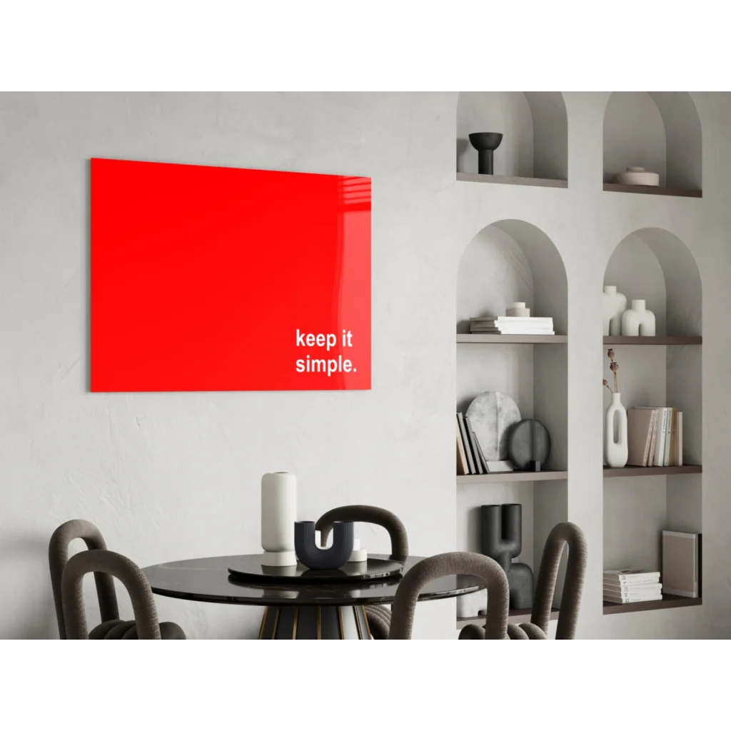 Bold red glass wall art with Keep It Simple in white lowercase