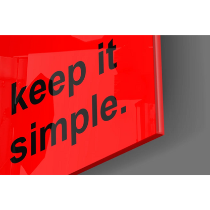 Glossy red glass wall art sign reading keep it simple
