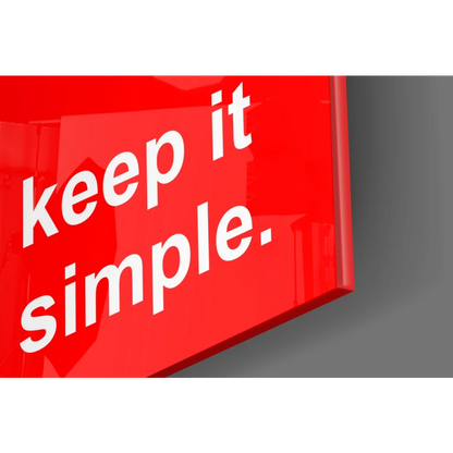Glossy red glass wall art with bold Keep It Simple text