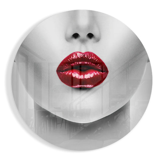 Circular glass wall art featuring a grayscale face with bright red glossy lips as the focal point against a white background.