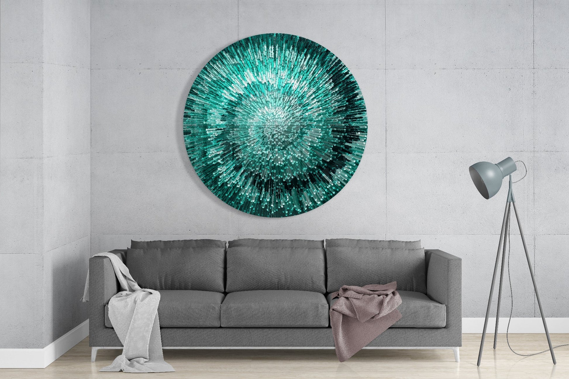 Emerald Helix Glass Wall Art displayed above a gray sofa in a minimalist living room with concrete walls and tripod floor lamp.