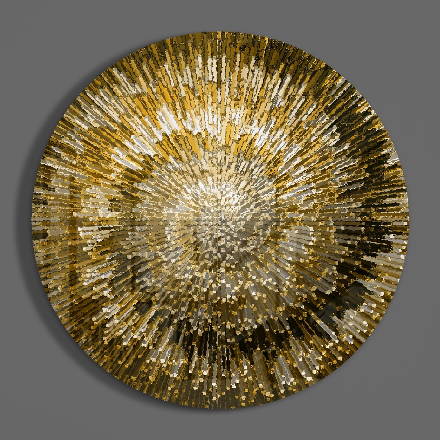 Circular golden glass wall art with radiating rectangular segments creating a sunburst pattern against gray background.