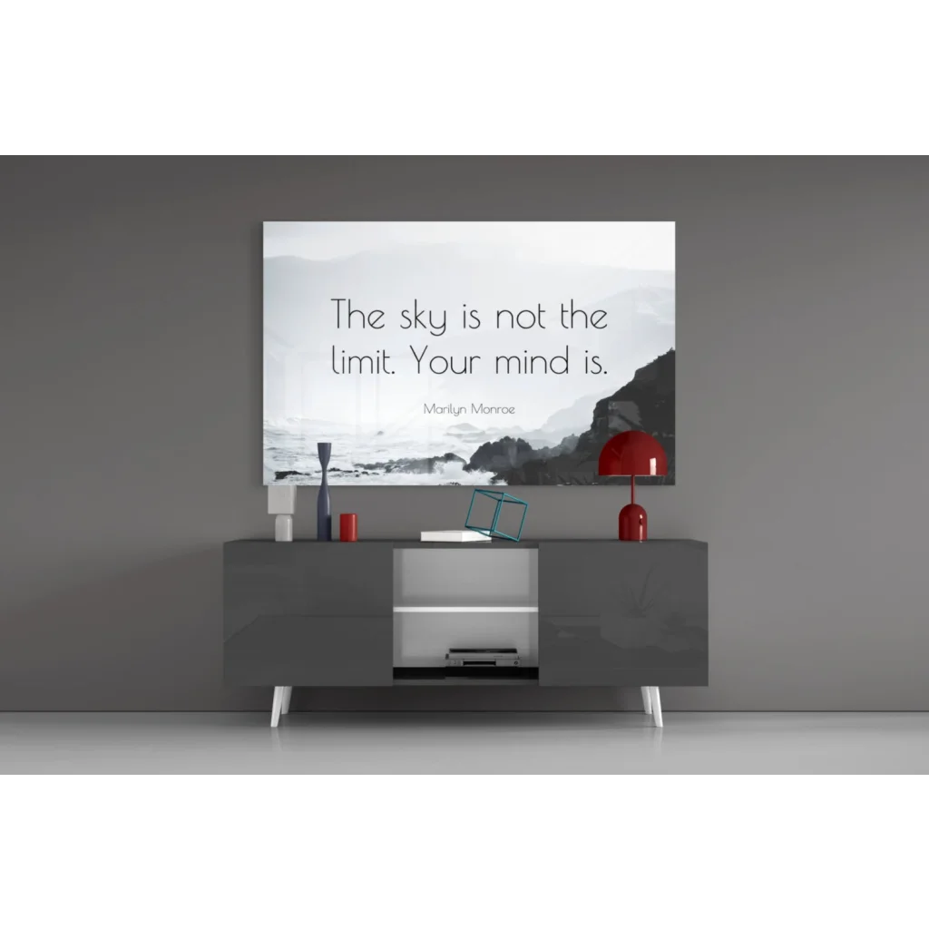 Sleek minimalist gray console table with white legs and open shelving for glass wall art display