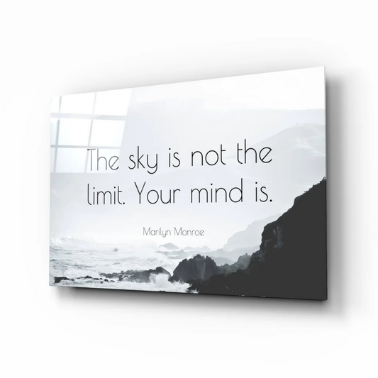 Sleek minimalist glass wall art of monochrome coastal landscape with the sky is not the limit quote