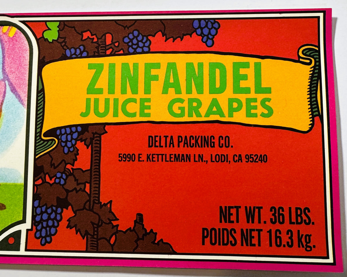 Right end of the Small Black crate label: ZINFANDEL JUICE GRAPES in green on a yellow scroll, DELTA PACKING CO., 5990 E. KETTLEMAN LN., LODI, CA 95240, and NET WT. 36 LBS. / POIDS NET 16.3 kg, with blue-purple grape clusters on red