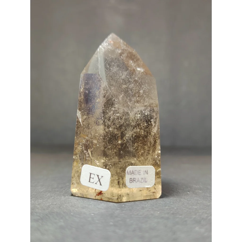 Smoky clear quartz polished free form sculpture in translucent golden brown with natural inclusions and pointed top