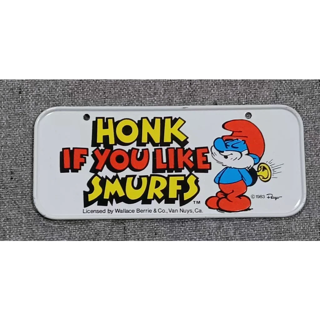 Rare 1983 Smurfs bicycle license plate with cartoon Smurf in red hat and blue outfit