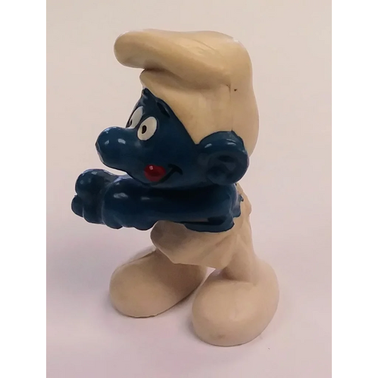 Vintage 1979 Baker Smurf PVC figure with blue skin, blonde hair, red nose