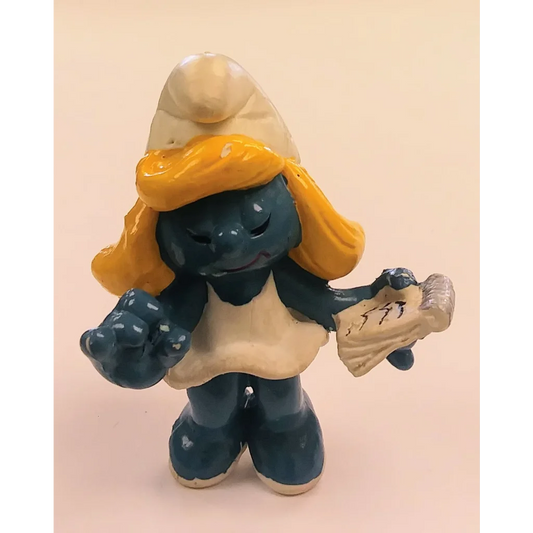 Vintage 1981 Secretary Smurfette Peyo Schleich ceramic figure with yellow hat and apron holding newspaper