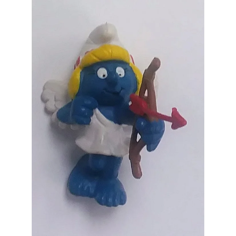 Rare 1982 Valentine Smurfette PVC figure with blonde hair, white dress, red arrow