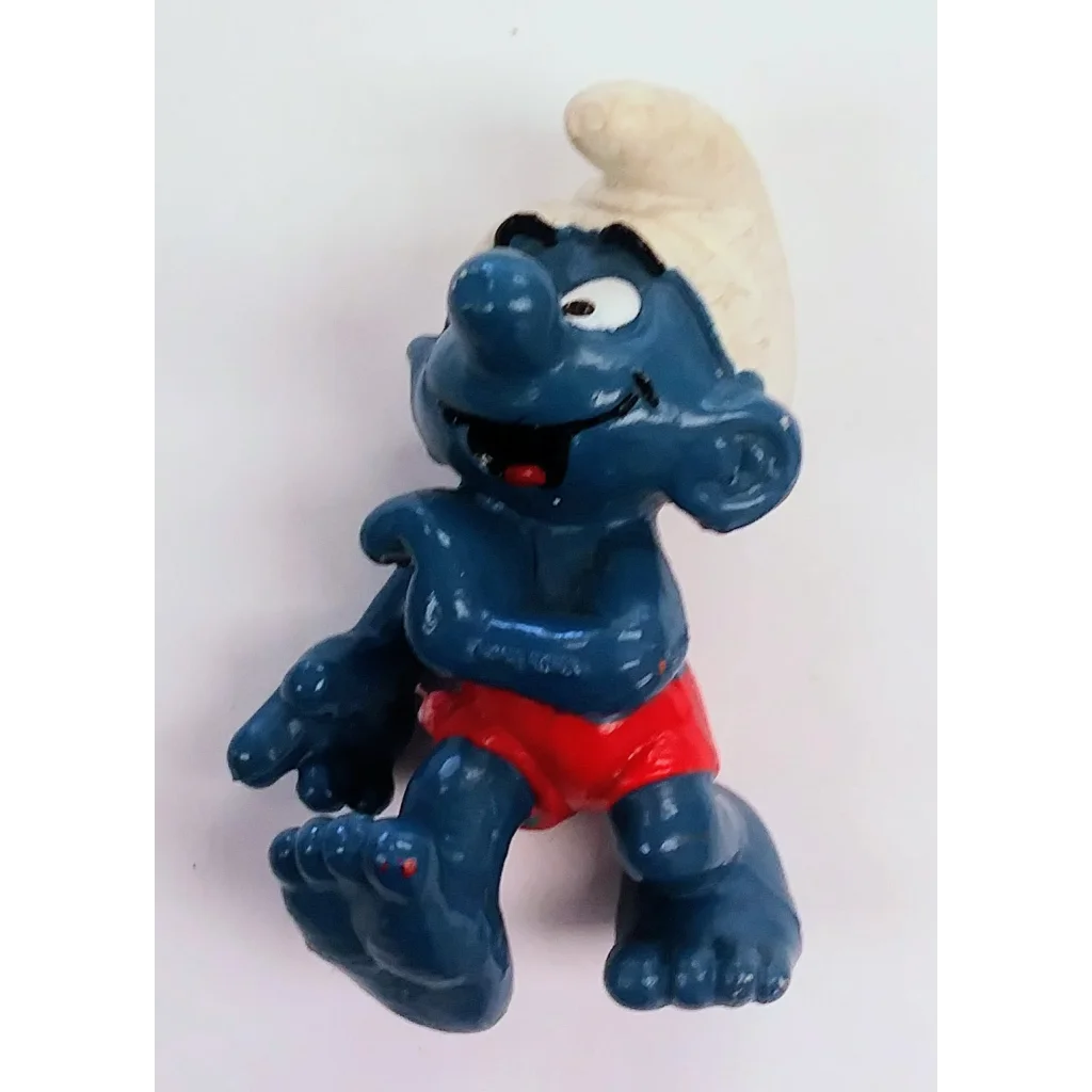 Vintage 1982 Surfer Smurf PVC figure toy with blue skin, red shorts, white hair