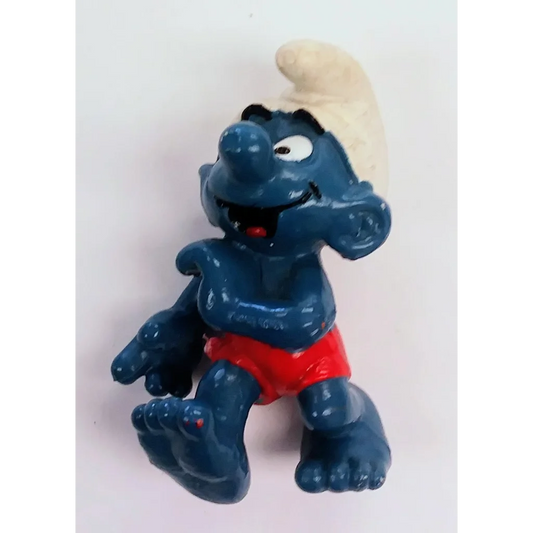 Vintage 1982 Surfer Smurf PVC figure toy with blue skin, red shorts, white hair