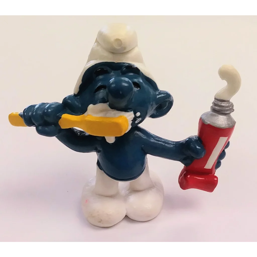 Rare 1979 toothpaste Smurf PVC figure with blue body, white hat, pants, red paste tube