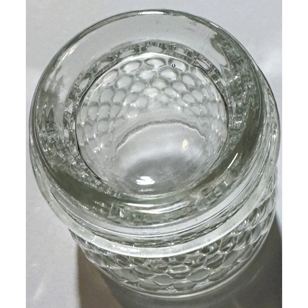 Clear glass container with textured exterior from vintage 1950s Anchor Hocking Hobnail collection